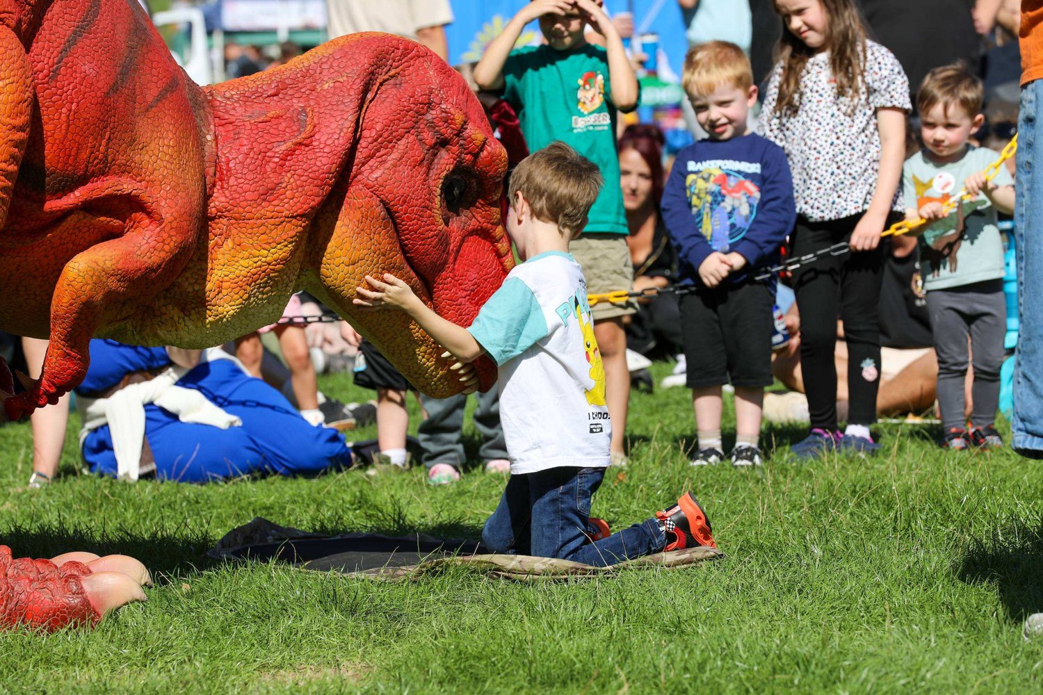 Children meeting the T-Rex at Haywards Heath Town Day 2026 in Victoria Park