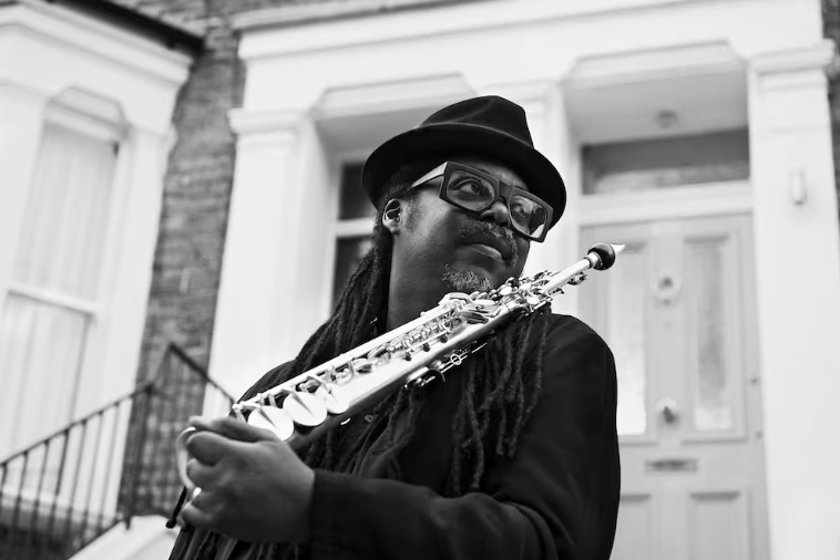 Courtney Pine holding a saxophone, appearing at Midhurst Jazz Festival