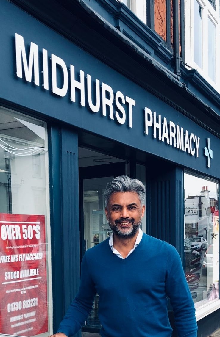 Raj Rohilla standing outside Midhurst Pharmacy