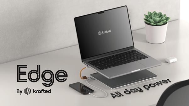 Krafted Edge power bank beneath a laptop, with a connected phone on a desk.