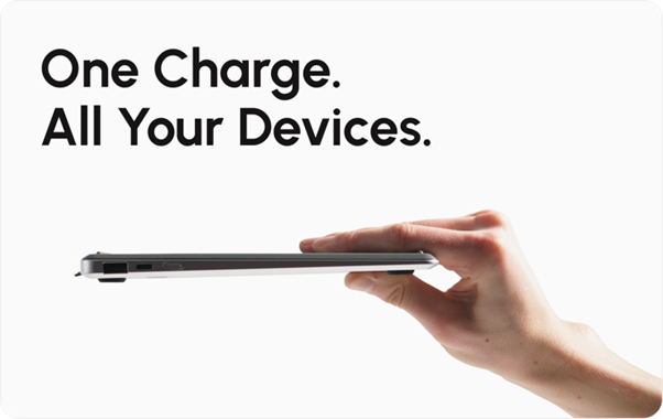 Hand holding the slim Krafted Edge power bank, with the words ‘One Charge. All Your Devices.’