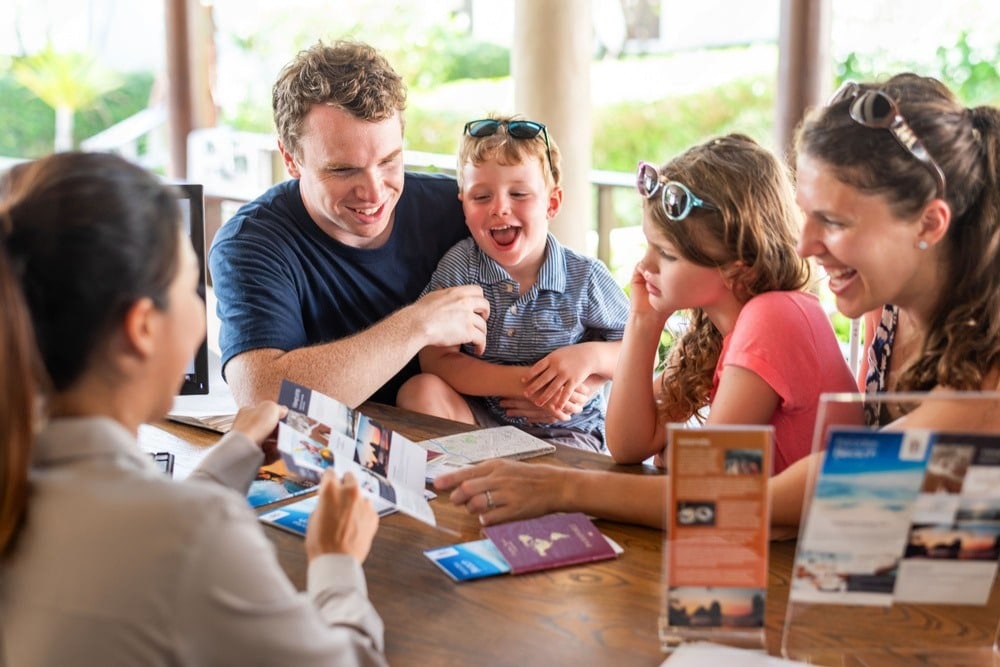 Family planning a family holiday together around a table