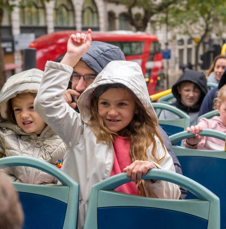 Children enjoying the London Kids Tour on the top deck of an open-top bus